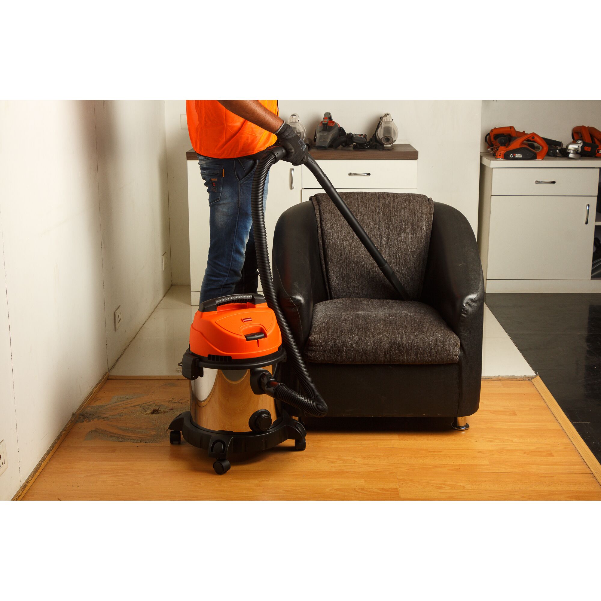 BLACKDECKER WDBDS20 wet dry vacuum cleaner used to clean sofa in a home interior.