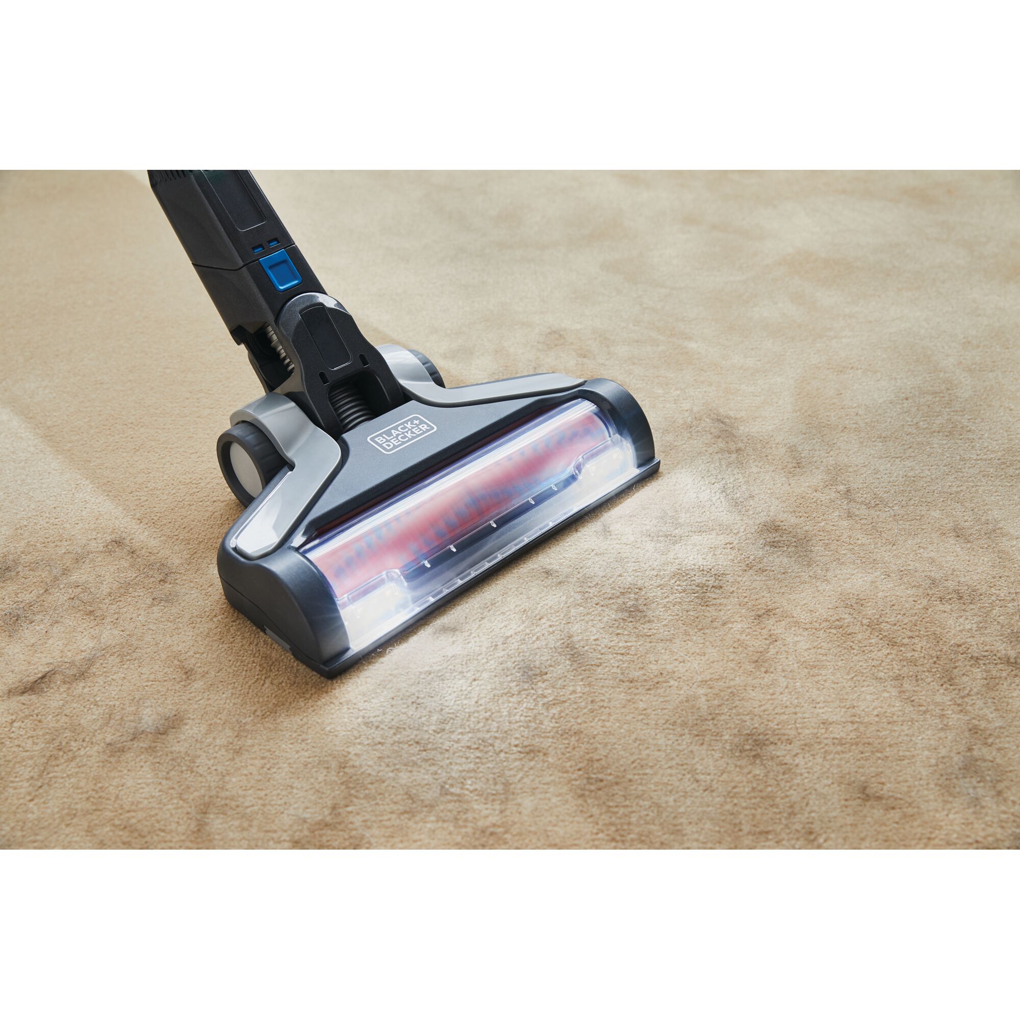 BLACKDECKER BSV2020G cordless vacuum cleaner head cleaning beige carpet, angled close-up.